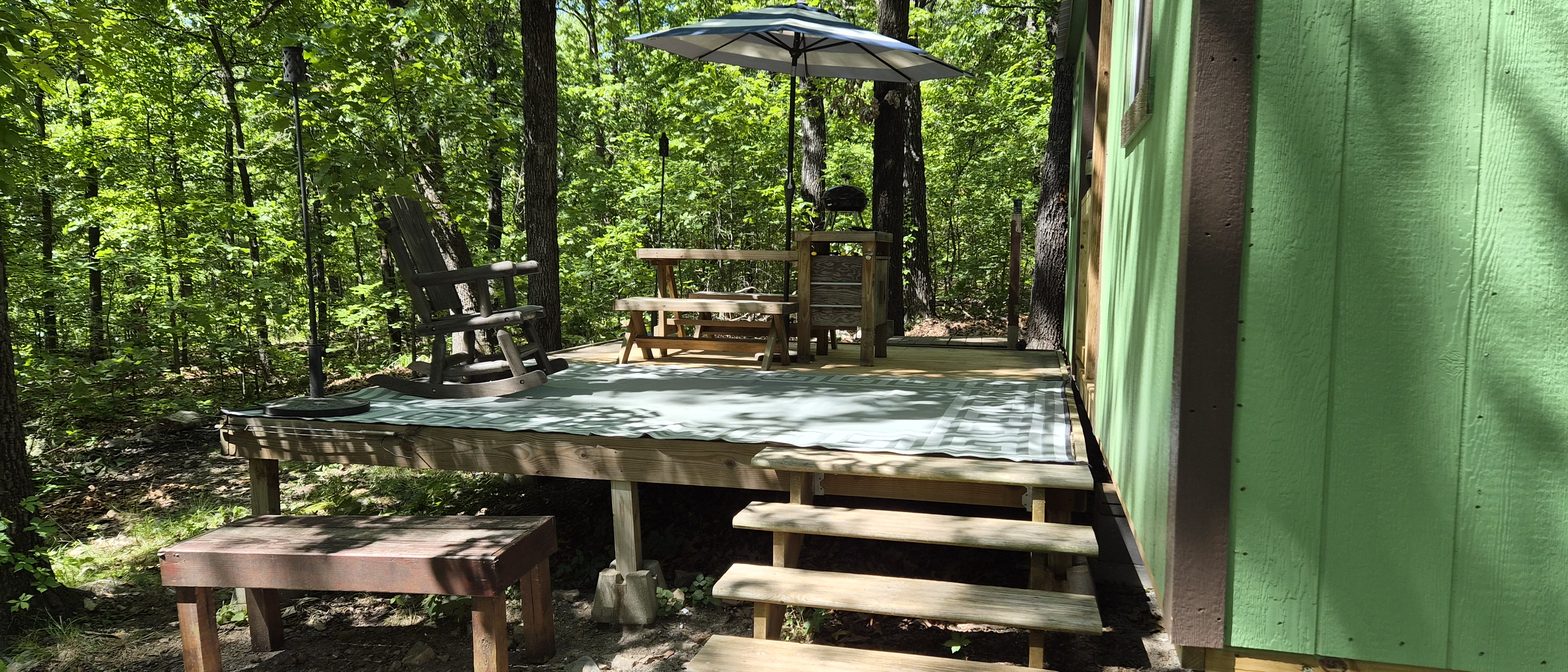 Side view of the cabin deck in the woods